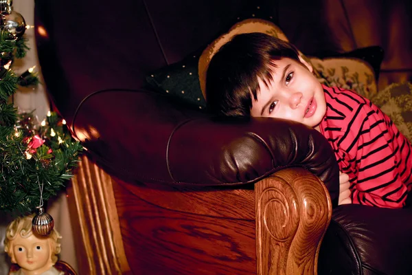 Pojken ser ut för julgran, inomhus — Stockfoto