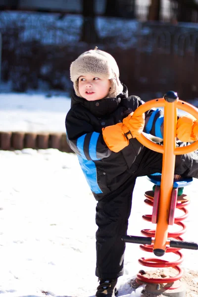 Boy on winter seesaw — Stock Photo, Image