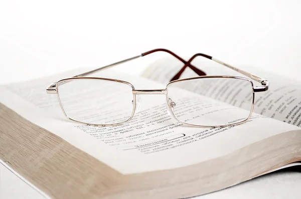 stock image Glasses on open book.