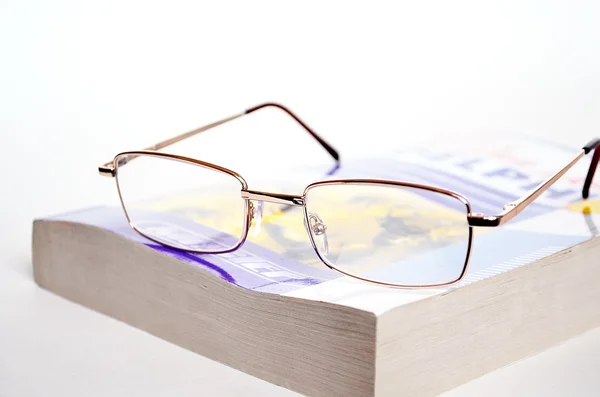 stock image Glasses on book.