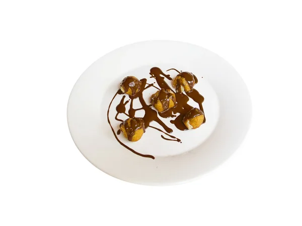 A plate with profiteroles and chocolat — Stock Photo, Image