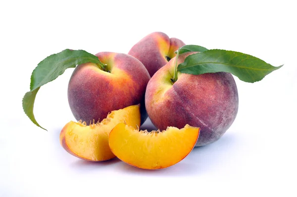 Peach and a half and leaves — Stock Photo, Image