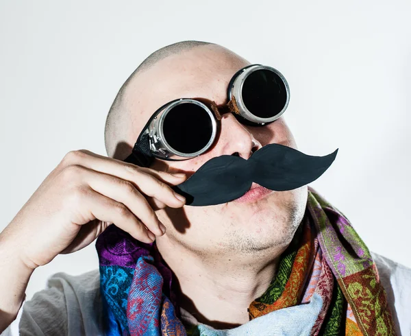 Man fiddles his false moustache Stock Picture