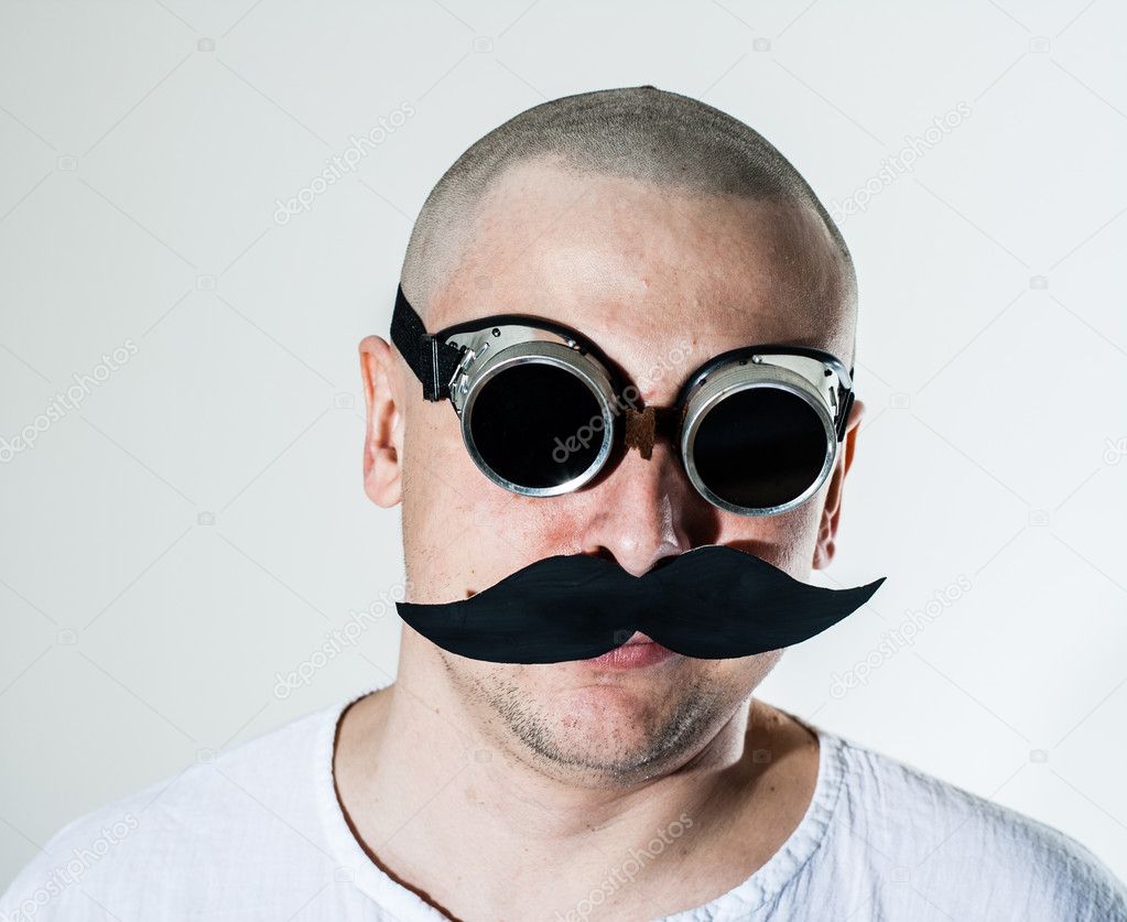 Man wearing false moustache and goggles
