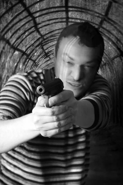 Black dressed man with gun — Stock Photo, Image