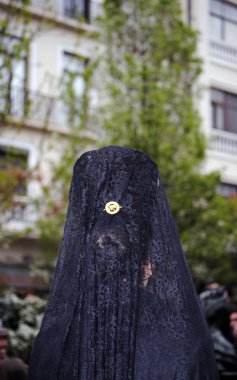 Woman with Mantilla participating in a procession of Holy Week in Granada clipart