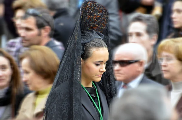 GRANADA, SPAIN - APRIL 6: Female participant in Easter Procession on April 6, 2012 in Granada, Spain. The woman carries the traditional head coverage called mantilla — Stock Photo, Image