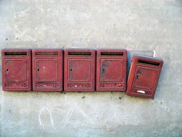 stock image Old red mail boxes on a grey wall