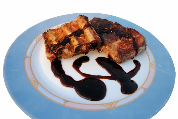 Grilled pork ribs whit sauce in a white dish — Stock Photo, Image