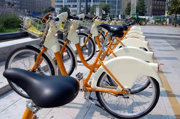 stock image Parked yellow bicycles, concept of bike sharing