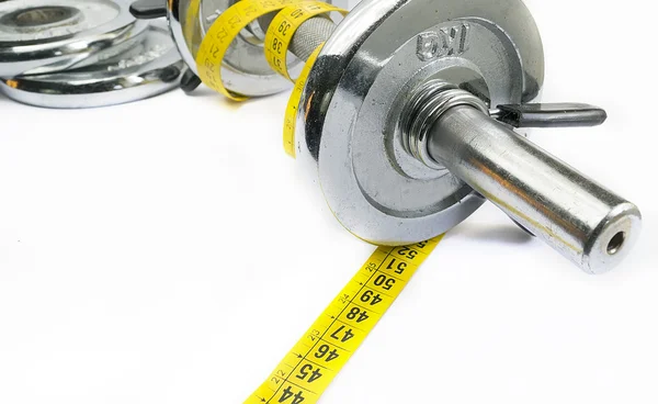 Meter tape around a metal dumbell — Stock Photo, Image