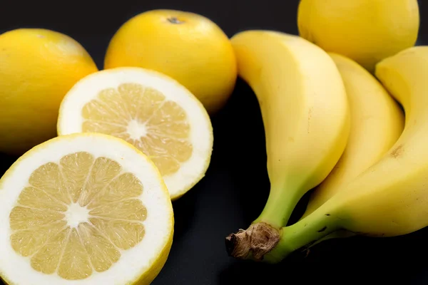 Yellow fruits on black — Stock Photo, Image