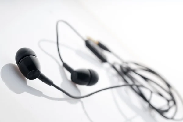 stock image Black in-ear headphones.