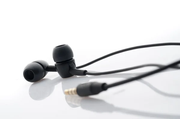 stock image Black in-ear headphones.