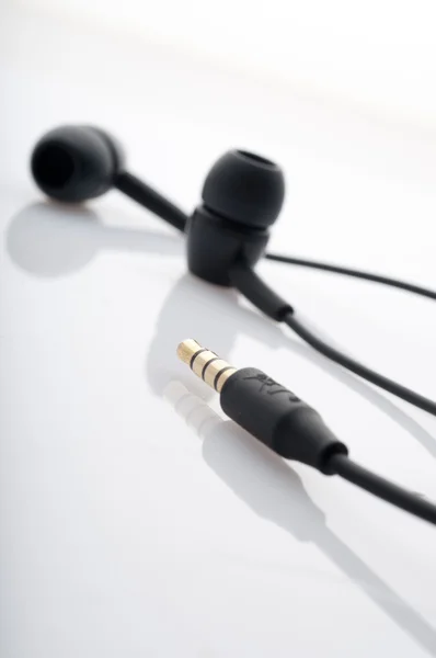 stock image Black in-ear headphones.