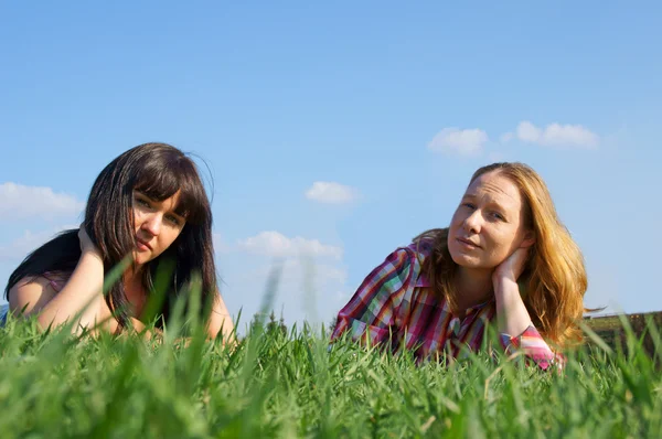 Δύο όμορφα κορίτσια είναι στο καταπράσινο γρασίδι — Φωτογραφία Αρχείου