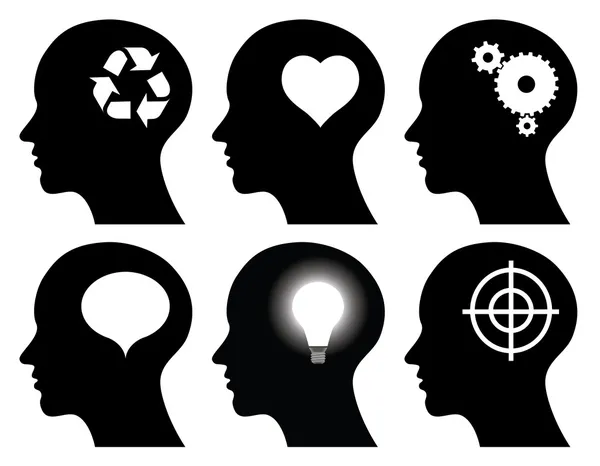 Black head profiles with idea symbols — Stock Vector