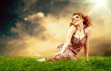 Young women dreaming on the outdoor background