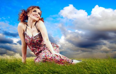 Young women dreaming on the outdoor background