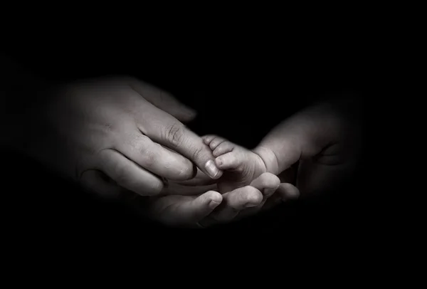 Babys foots in father hands on the monochrome background — Stock Photo, Image