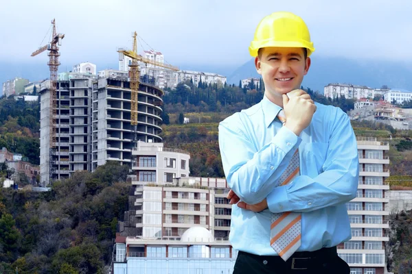 stock image Young architect wearing a protective helmet standing on the moun