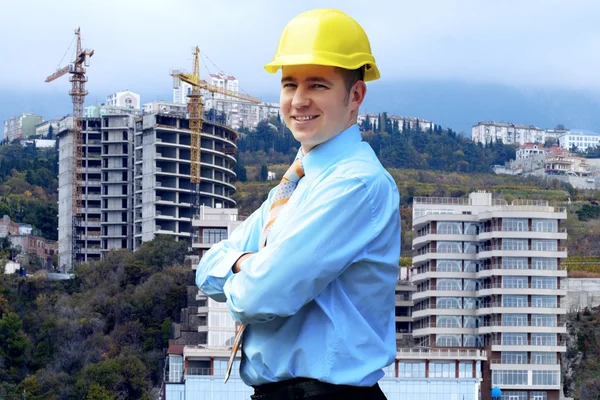 Молодий архітектор у захисному шоломі, що стоїть на кріпленні — стокове фото