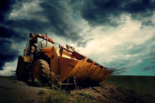 Yellow tractor on sky background — Stock Photo, Image