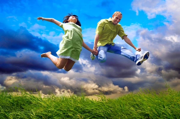 Fun couple in jump on the outdoor background Royalty Free Stock Images