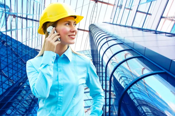Young architect-woman wearing a protective helmet standing on th Royalty Free Stock Photos