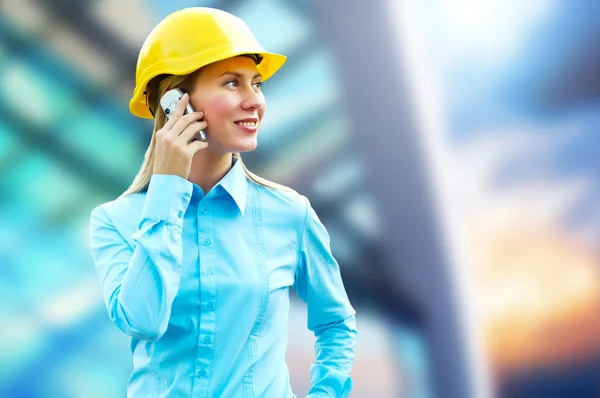 Young architect-woman wearing a protective helmet standing on th Royalty Free Stock Images