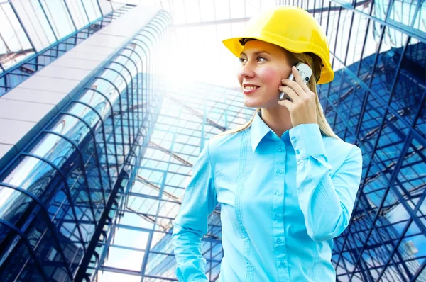 Young architect-woman wearing a protective helmet standing on th Stock Photo