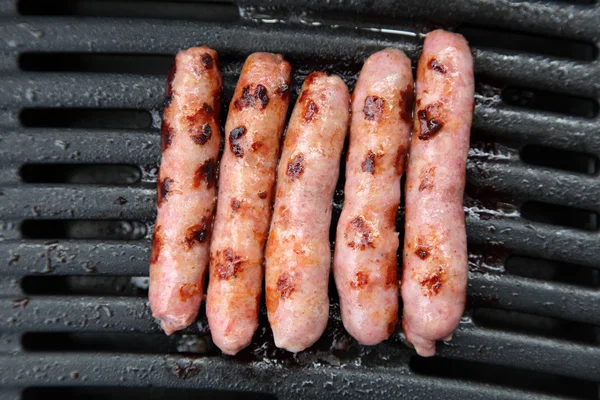 stock image Sausages on a bbq grill