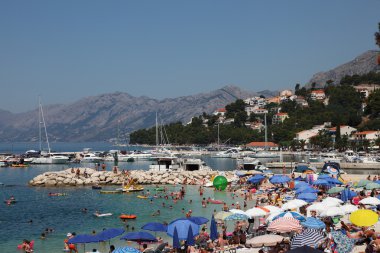 Crowded beach in the Adriatic resort Brela, Croatia. clipart