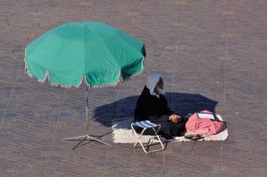 Fortune teller on Djemaa el Fna square in Marrakesh. clipart