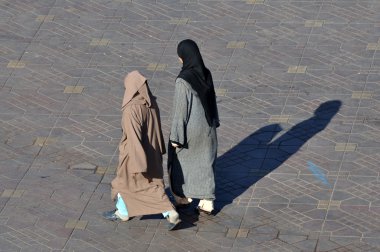 Two muslim women walking in Marrakesh, Morocco. clipart