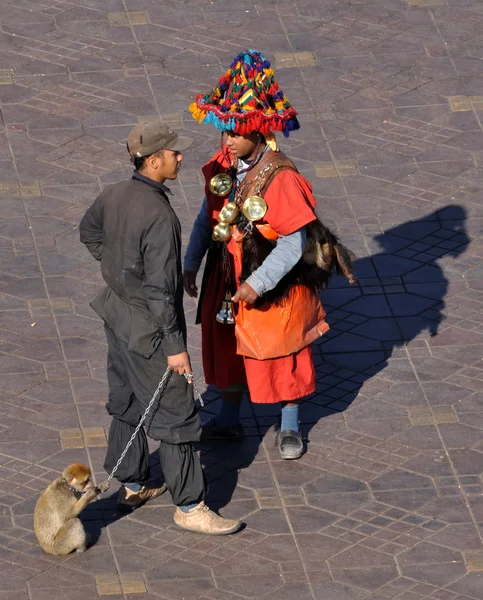 stock image Waterseller and man with monkey, Djemaa el Fna square in Marrakesh