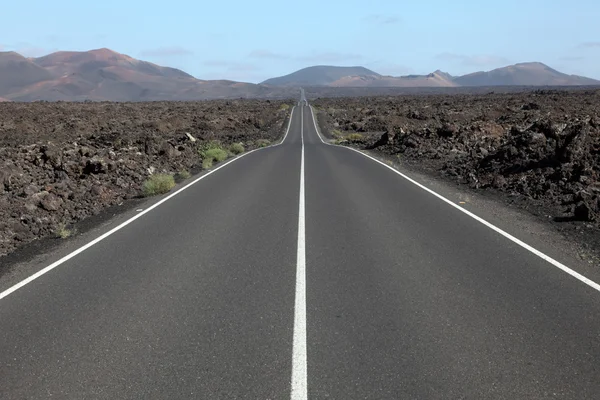 Road through the lava fields on Lanzarote, Spain — Stock Photo, Image