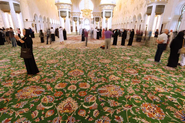 Návštěvníci uvnitř mešita šejka Zayeda v Abú Dhabí — Stock fotografie
