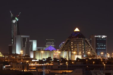 WAFI Mall in Dubai City illuminated at night clipart