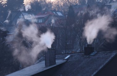Chimneys of residential houses in early winter morning. Siegen, Germany clipart