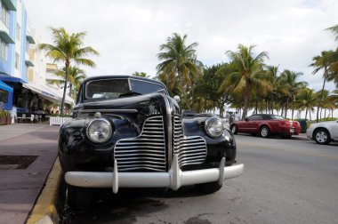 Vintage Car in Miami Beach Art Deco District Ocean Drive, Florida clipart