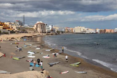 Surfers on the beach of El Medano, Canary Island Tenerife clipart