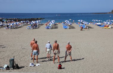 Men playing Petanque on the beach. Playa de las Vistas, Los Cristianos, Tenerife clipart