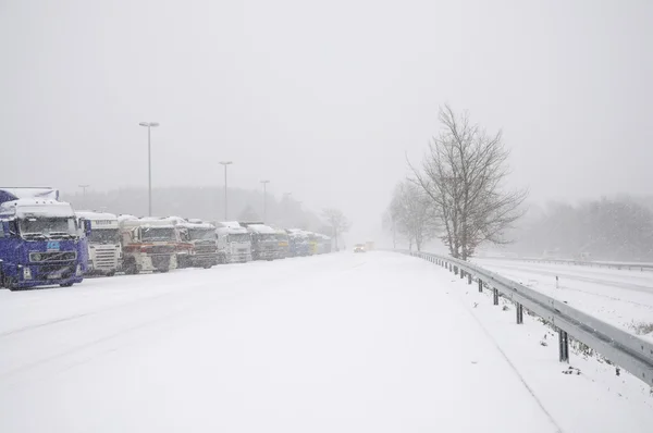 stock image Trucks on a parking place on a German Autobahn in winter