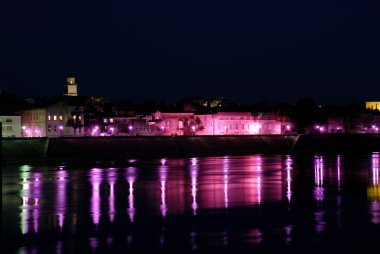 Streetlights reflecting in river Rhone at Arles, southern France clipart