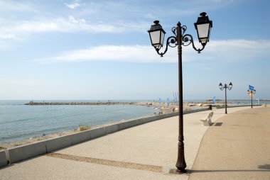 Promenade in Saintes-Maries-de-la-Mer, France clipart