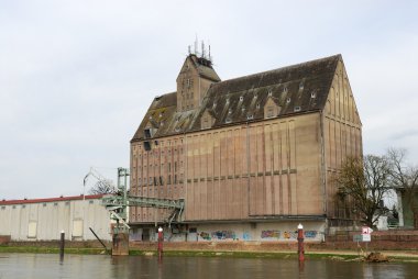 Old industrial storage building at river Weser in Germany clipart