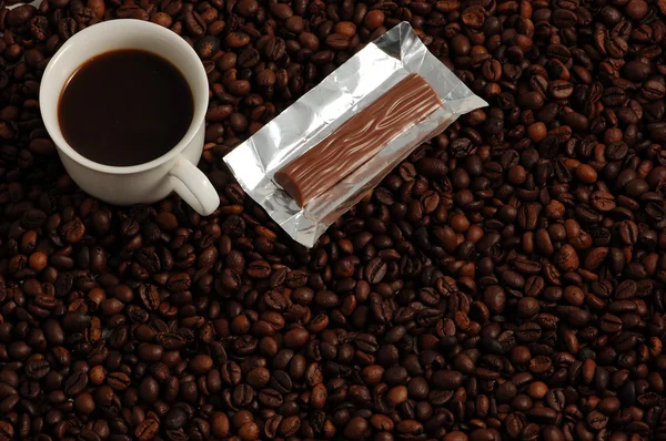 Tasse Kaffee mit süßer Praline — Stockfoto