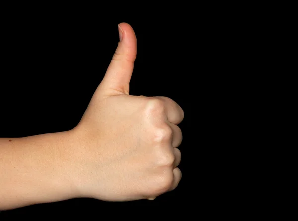 Thumbs up over a black background — Stock fotografie