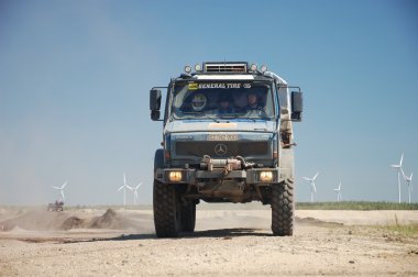 Mercedes Benz Unimog rally truck at offroad competition clipart
